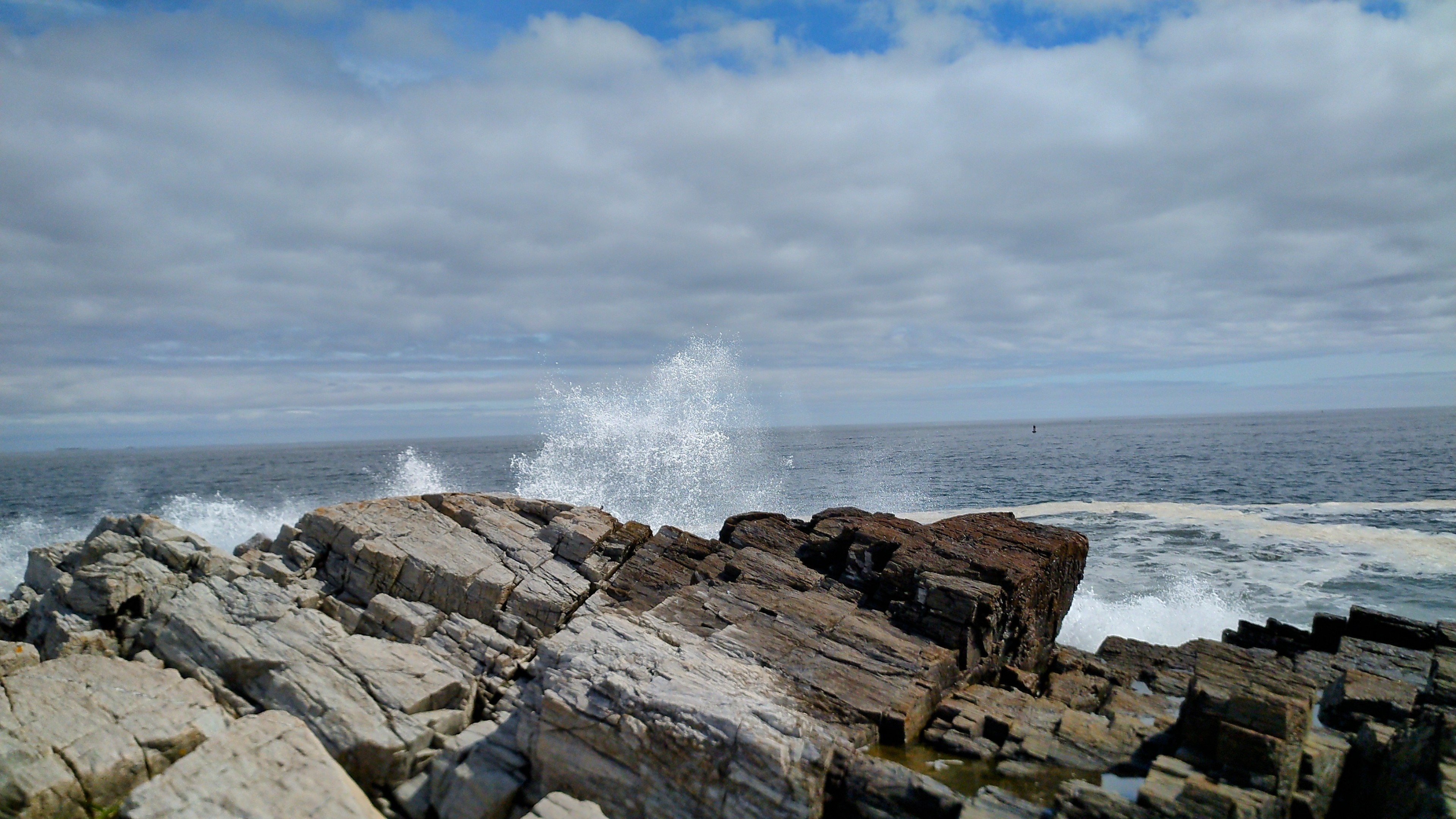 sea water crashing on rocks